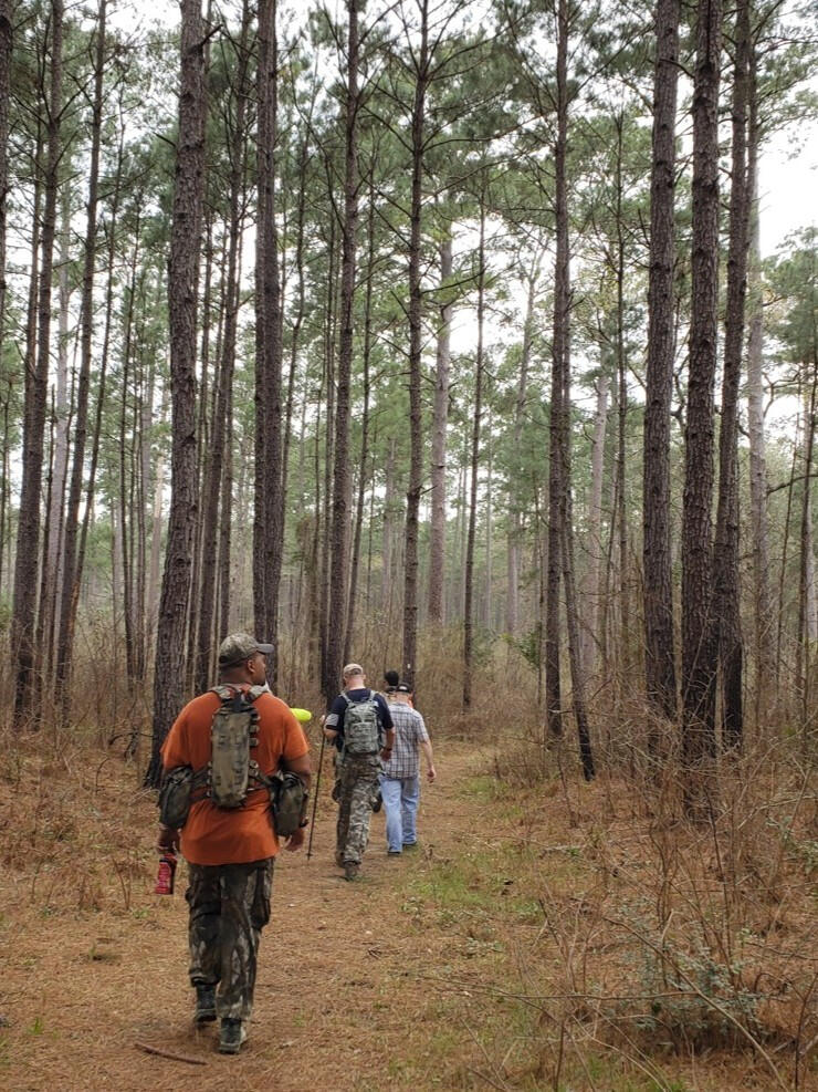 Smelling the Pines Men hiking through the Sam Houston National Forest during a rugged Catholic men's retreat